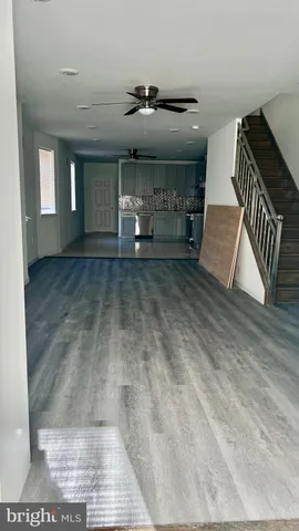 a view of a livingroom with furniture and staircase