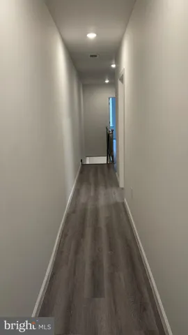 a view of hallway with wooden floor