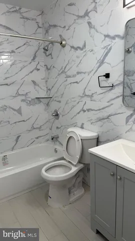 a bathroom with a toilet a sink and a shower