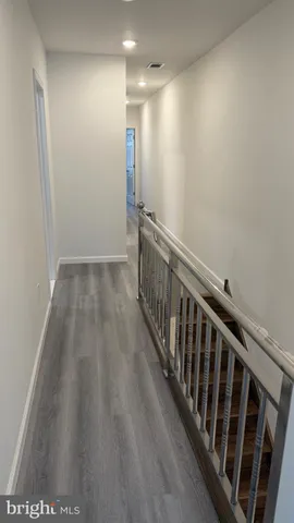 a view of hallway with wooden floor