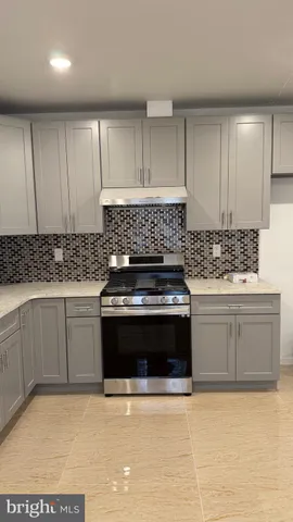 a kitchen with granite countertop a stove and a sink