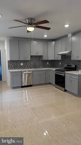 a kitchen with a stove a sink and cabinets