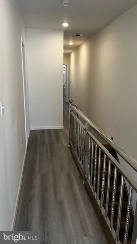 a view of hallway with wooden floor