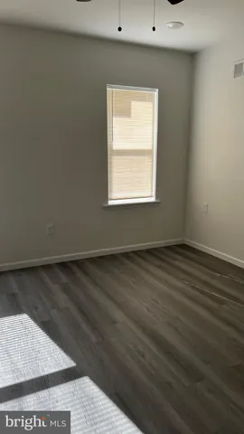 an empty room with wooden floor
