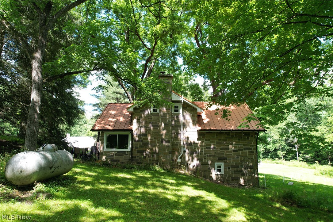 11811 Gaston Road Rogers, OH 44455 - Photo 10 of 38 The Cabin (stone-style facade) features 3 bedrooms, two bathrooms, a full-size basement, and is fully applianced with septic, well, and a geo-thermal furnace! Spend your evenings here while you build-out, or make the cabin your forever getaway and spend your days, hiking, hunting, or fishing!