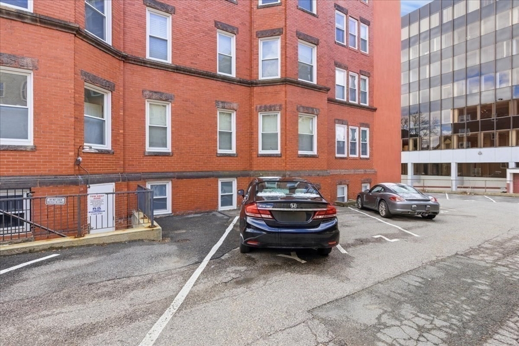 18 Centre Street, Unit 304 Cambridge, MA 02139 - Photo 17 of 17 a car parked in front of a brick building