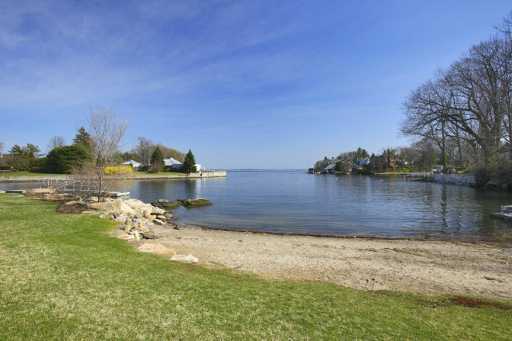 Undisclosed Address Old Greenwich, CT 06870 - Photo 2 of 8 a view of a lake with houses in the background