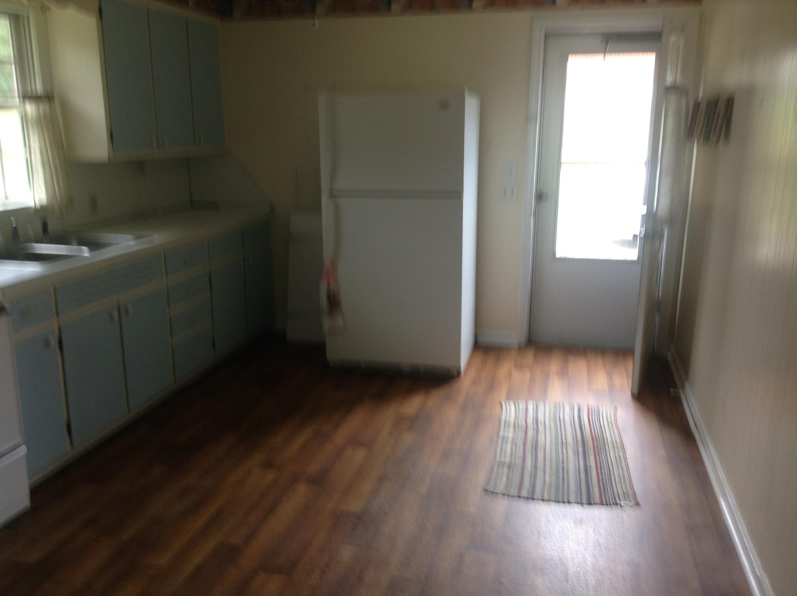 640 Power Dam Road Rocky Mount, VA 24151 - Photo 2 of 9 an empty room with wooden floor and windows