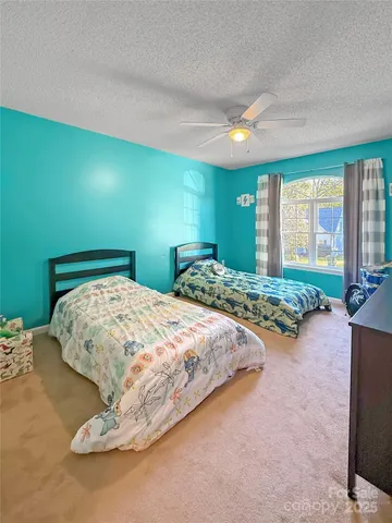 a spacious bedroom with a bed and a cabinets