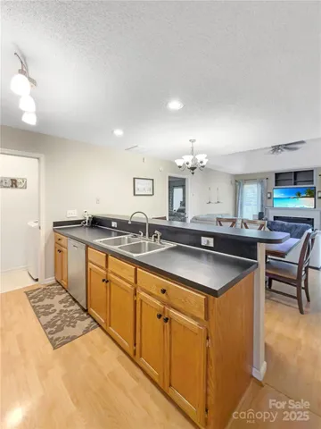 a kitchen with stainless steel appliances granite countertop a sink and a stove