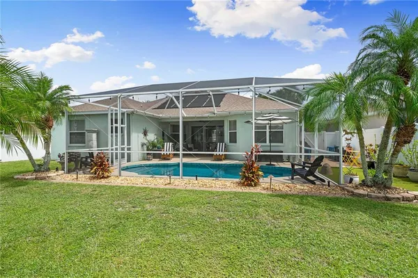 a view of a house with backyard porch and sitting area