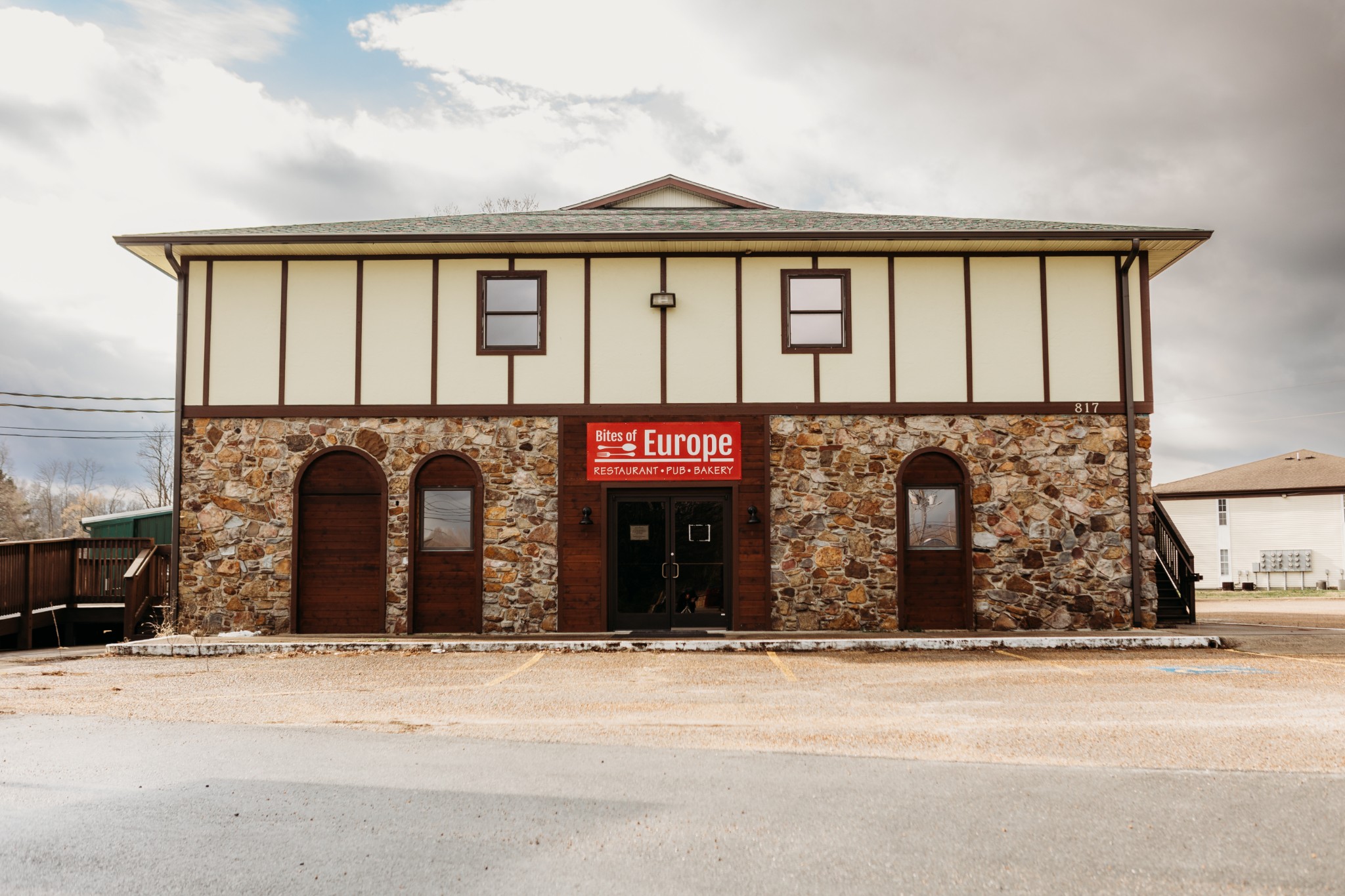 a front view of a building with a parking area