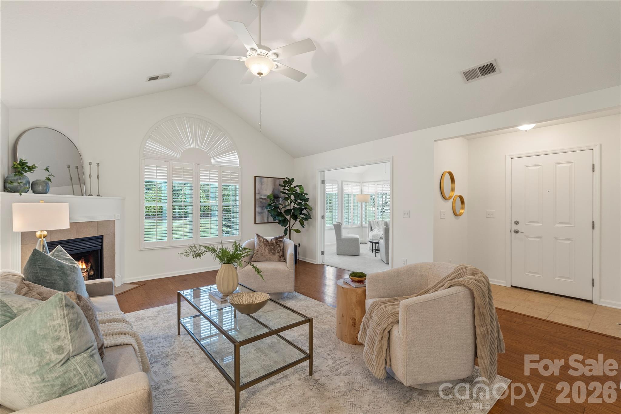2444 Coltsview Lane Matthews, NC 28105 - Photo 17 of 43 a living room with furniture a fireplace and a chandelier