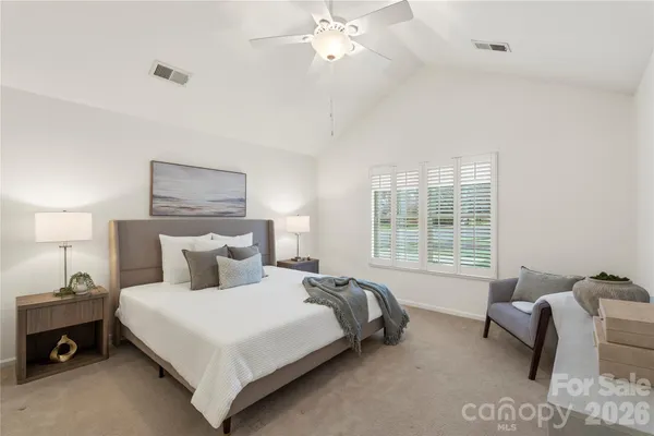 a bedroom with a bed and a couch