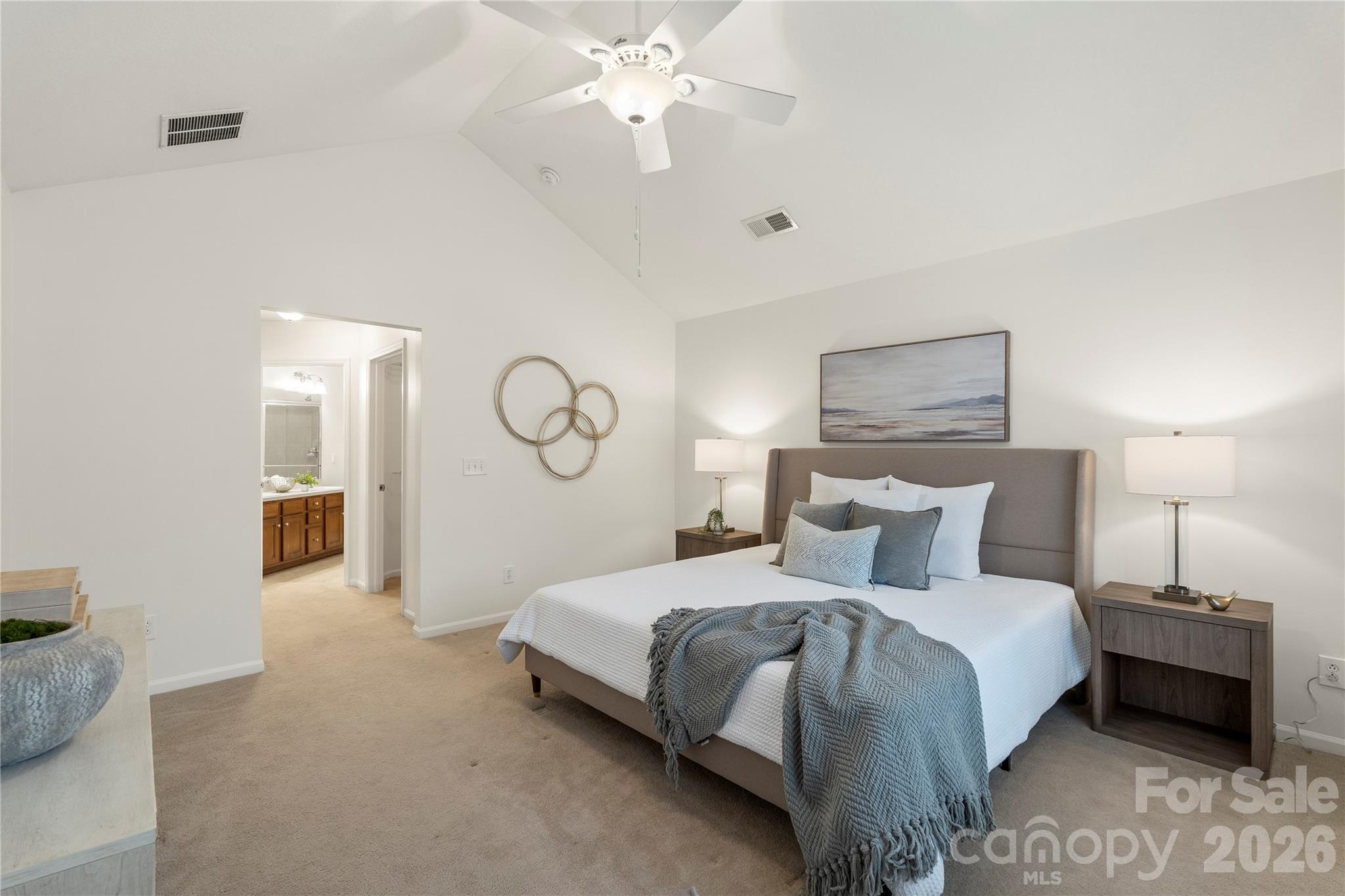 2444 Coltsview Lane Matthews, NC 28105 - Photo 20 of 43 a bedroom with a bed and a chandelier