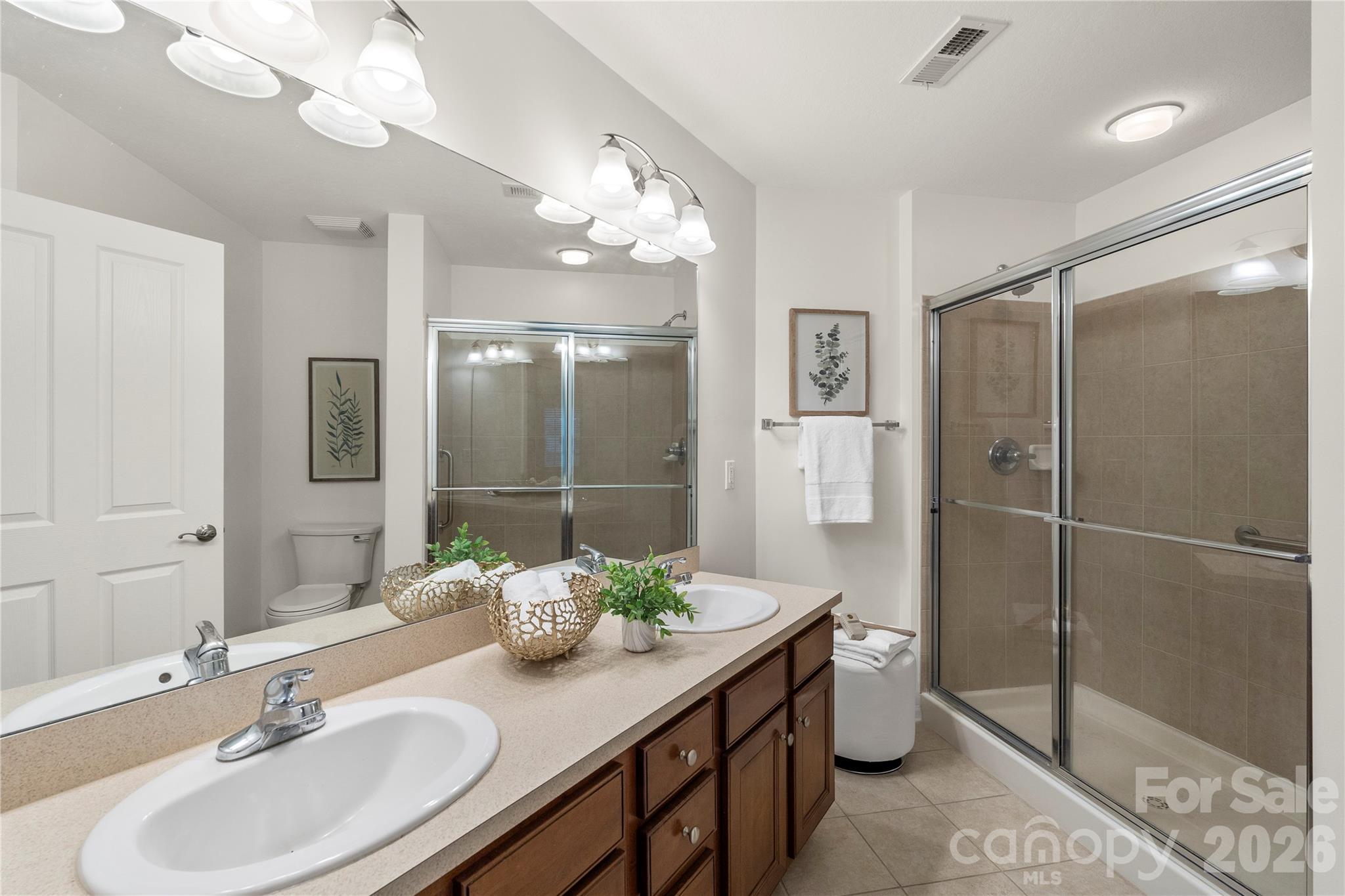 2444 Coltsview Lane Matthews, NC 28105 - Photo 22 of 43 a bathroom with a double vanity sink mirror and shower