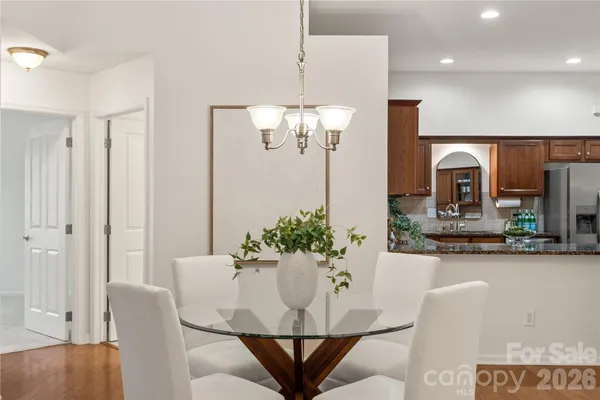 a view of a dining room with furniture and chandelier