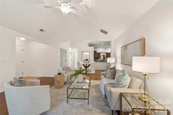 a living room with furniture and a lamp