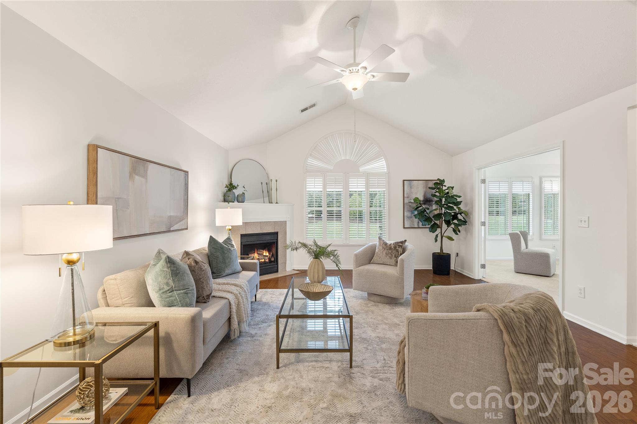 2444 Coltsview Lane Matthews, NC 28105 - Photo 4 of 43 a living room with furniture a chandelier and a fireplace