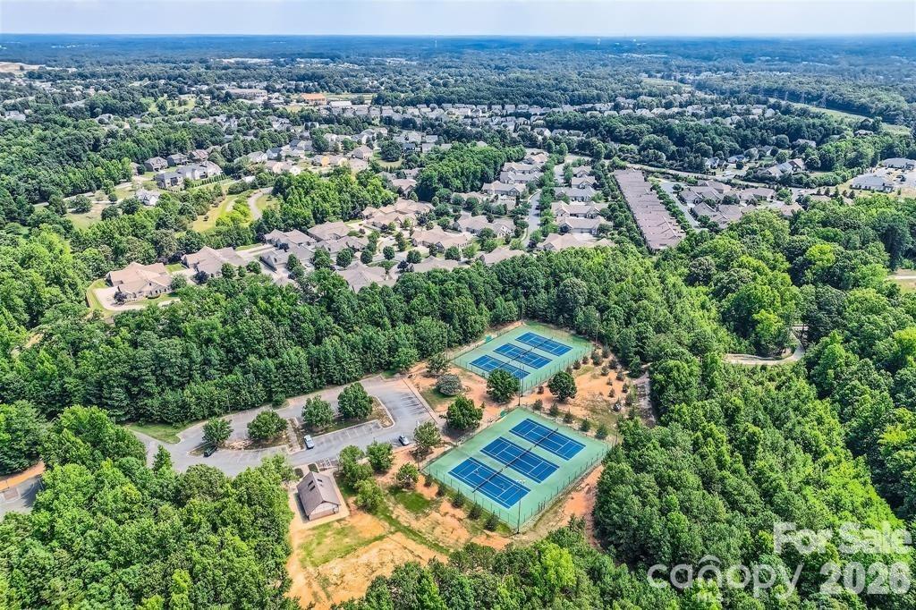 2444 Coltsview Lane Matthews, NC 28105 - Photo 42 of 43 an aerial view of a house with a yard and lake view