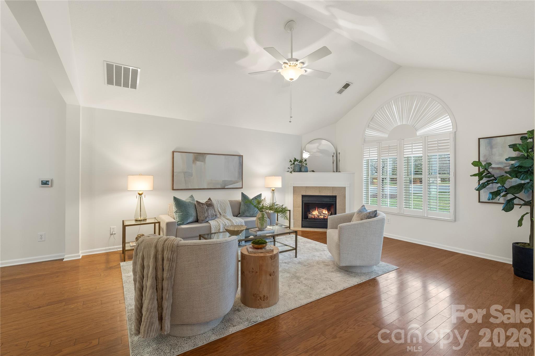 2444 Coltsview Lane Matthews, NC 28105 - Photo 5 of 43 a living room with furniture a fireplace and a chandelier