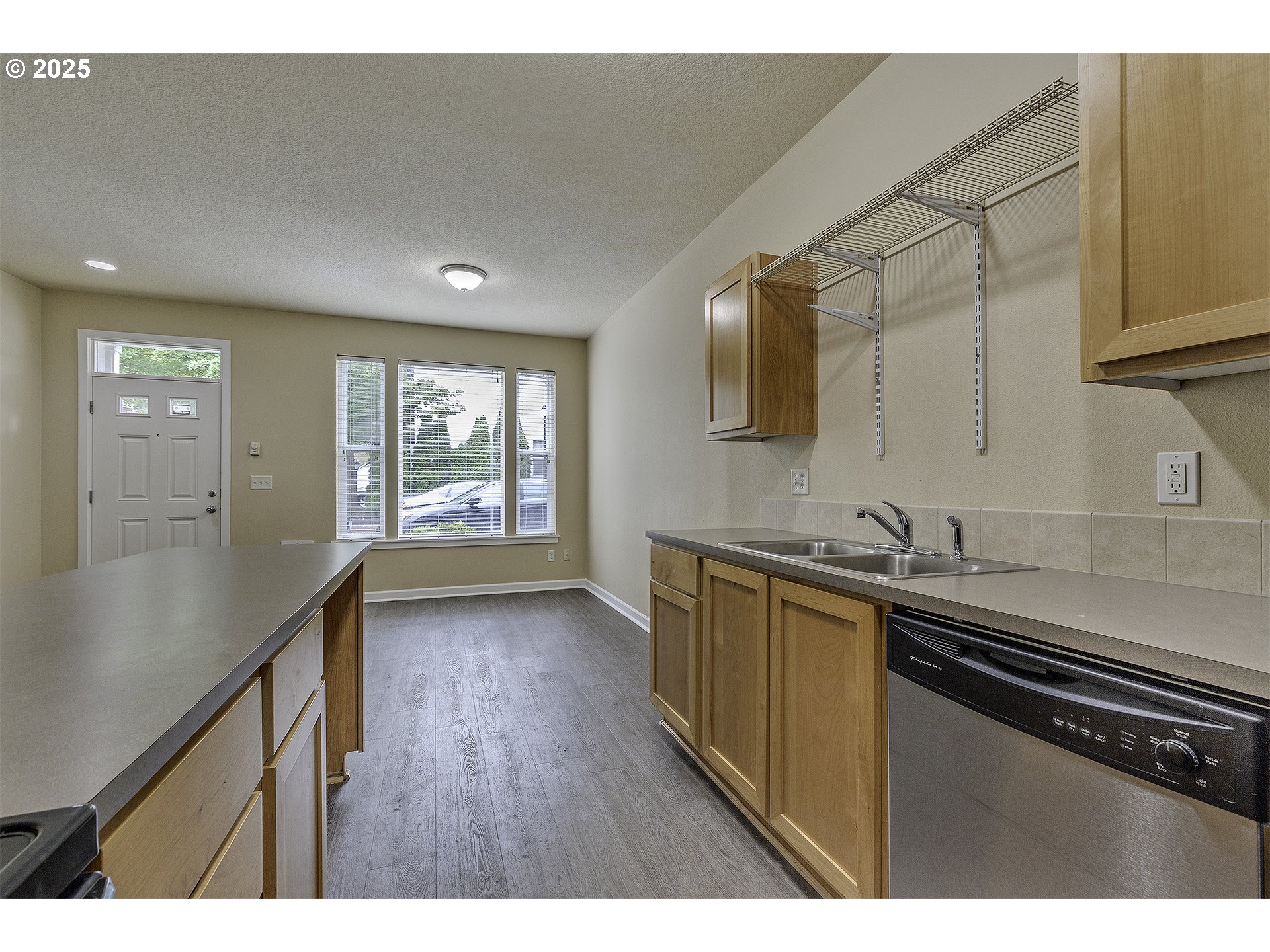 18483 Southwest Annamae Lane Beaverton, OR 97003 - Photo 11 of 23 a kitchen with stainless steel appliances a sink dishwasher a stove a refrigerator and wooden floor
