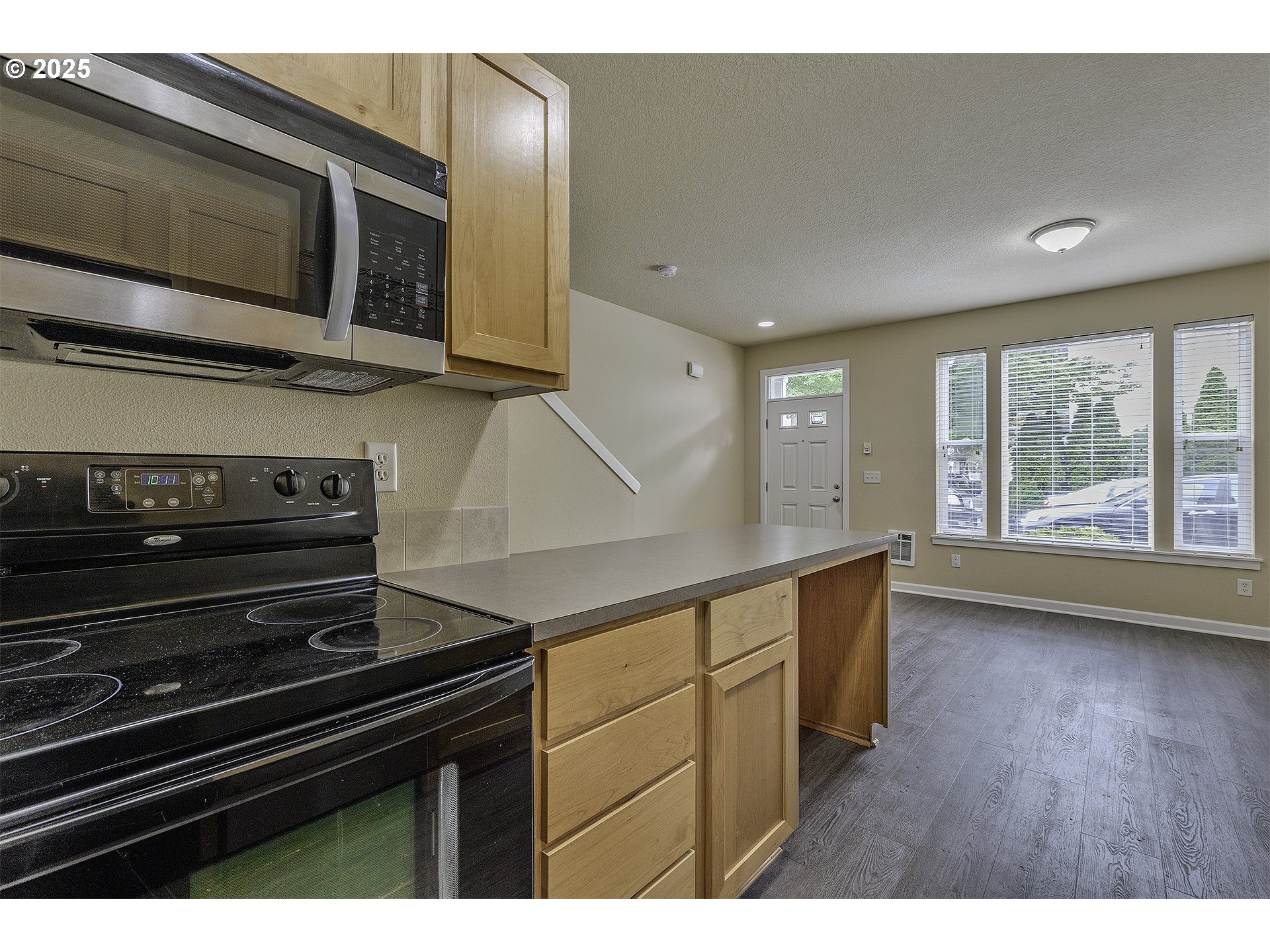 18483 Southwest Annamae Lane Beaverton, OR 97003 - Photo 12 of 23 a kitchen with stainless steel appliances a stove microwave and cabinets