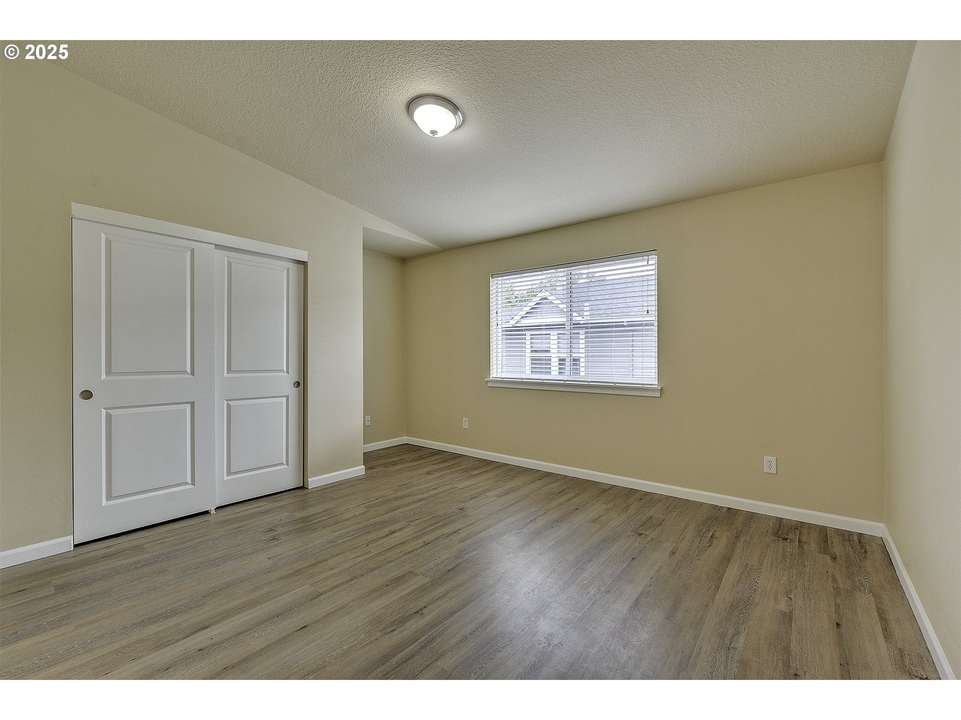 18483 Southwest Annamae Lane Beaverton, OR 97003 - Photo 15 of 23 a view of an empty room with wooden floor and a window