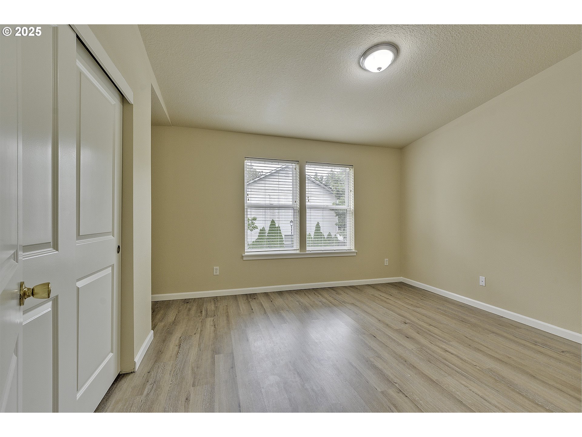 18483 Southwest Annamae Lane Beaverton, OR 97003 - Photo 18 of 23 a view of an empty room with wooden floor and a window