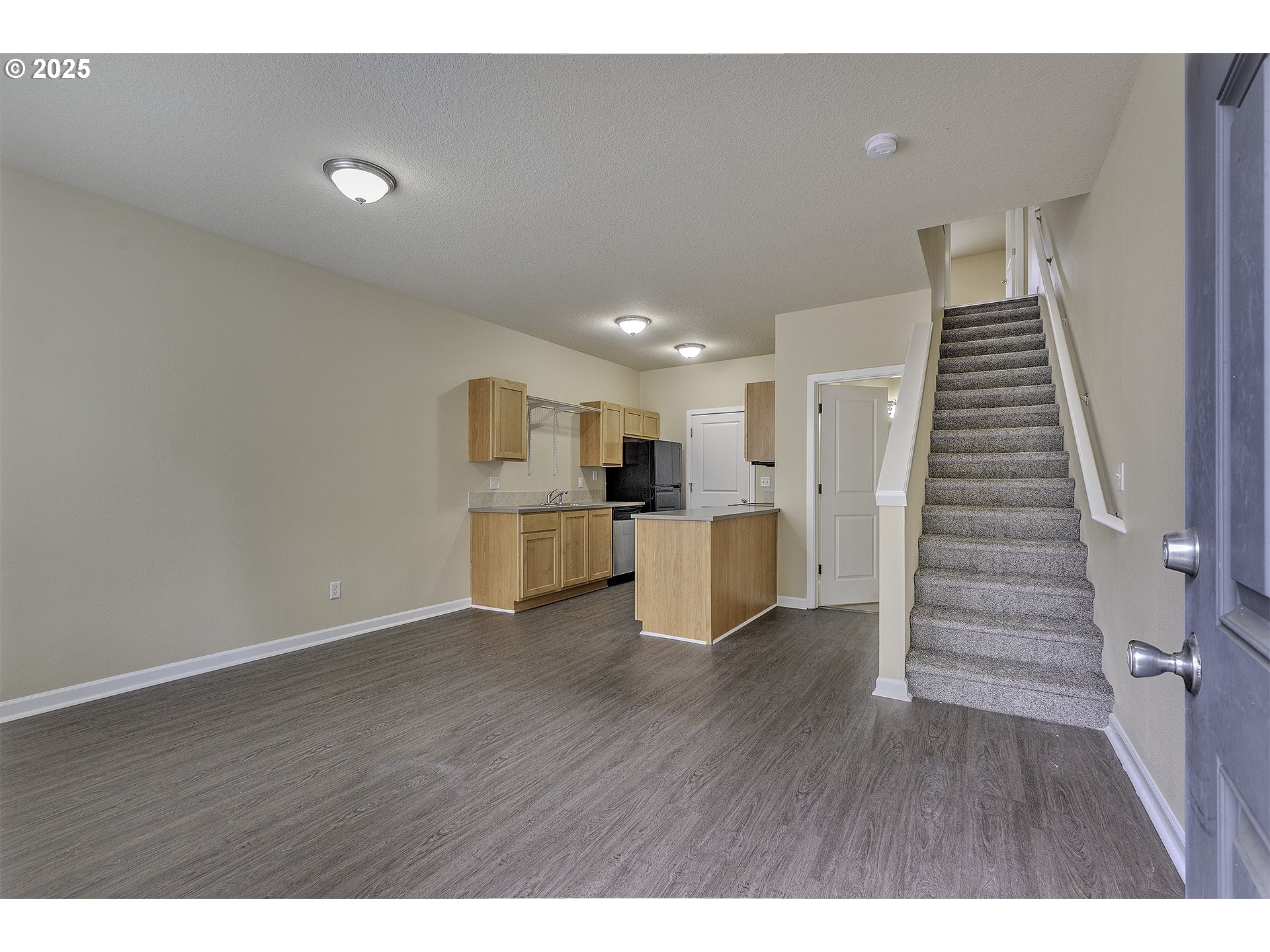 18483 Southwest Annamae Lane Beaverton, OR 97003 - Photo 2 of 23 a view of a kitchen with wooden floor and stairs