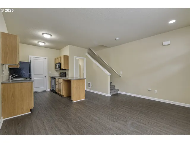 a view of kitchen with wooden floor and electronic appliances