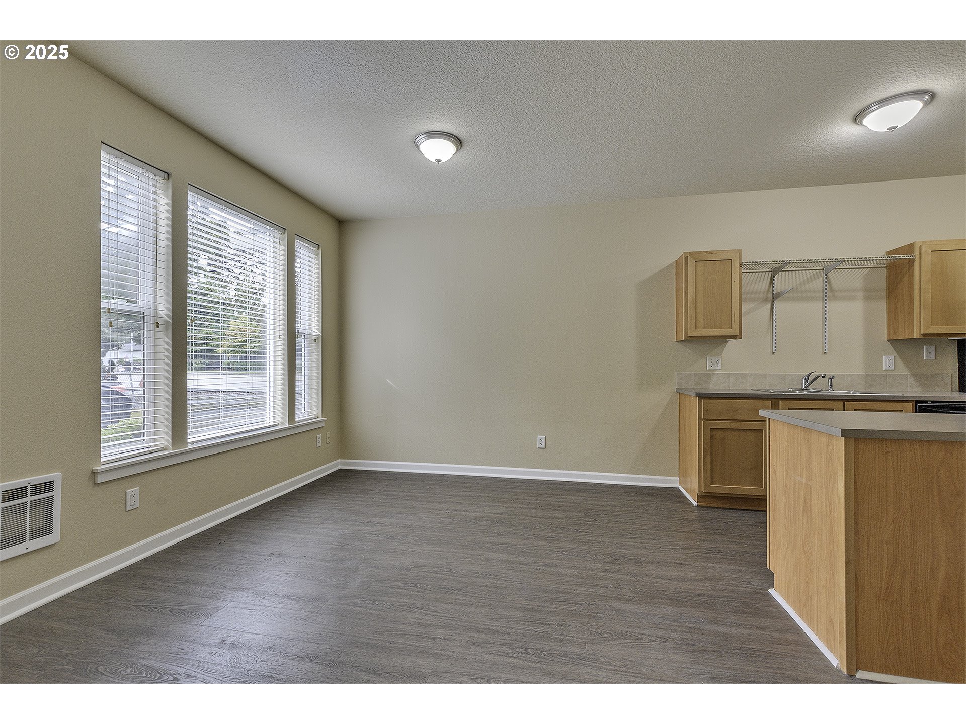 18483 Southwest Annamae Lane Beaverton, OR 97003 - Photo 6 of 23 a view of a kitchen with wooden floor and a kitchen