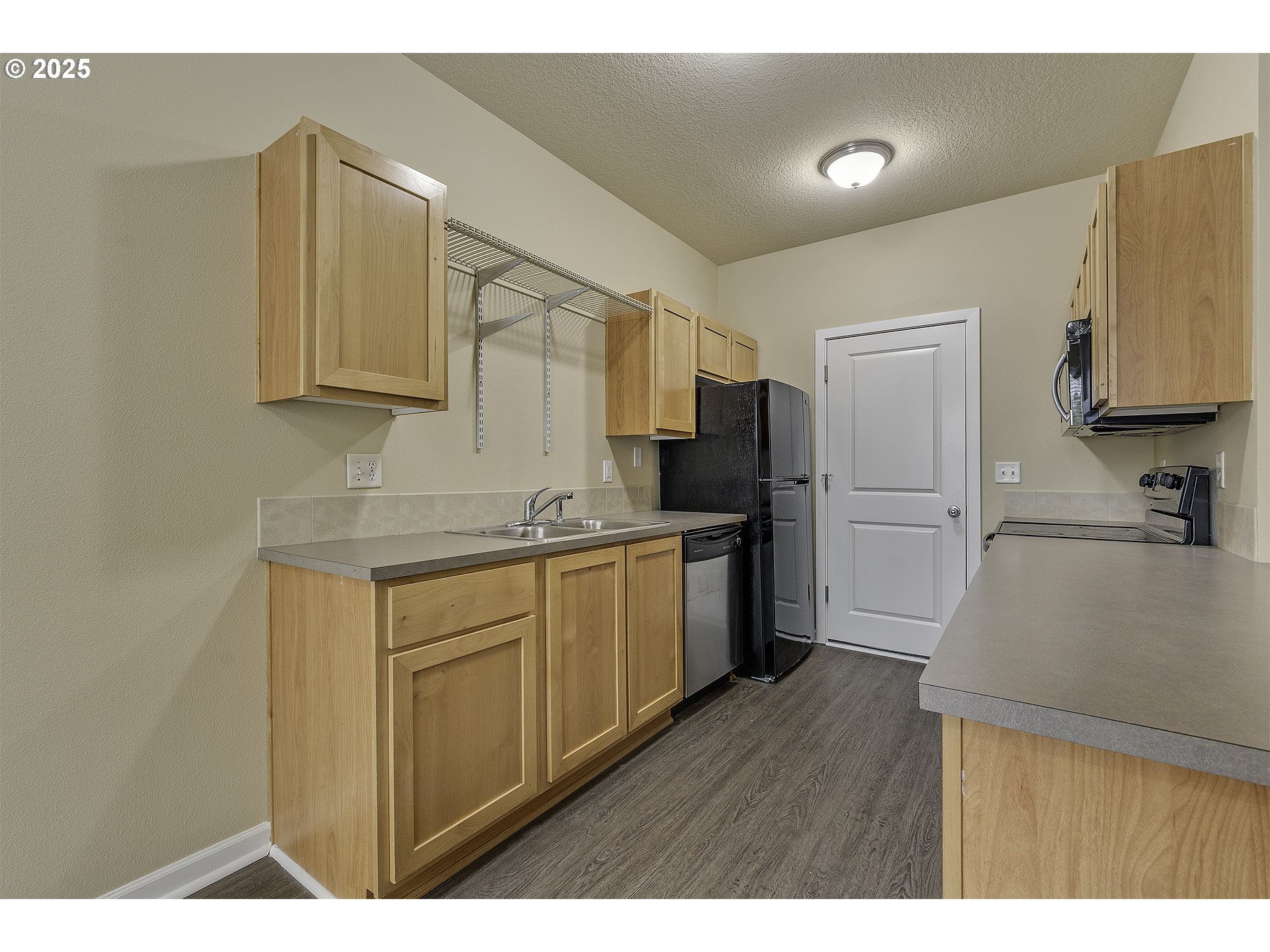 18483 Southwest Annamae Lane Beaverton, OR 97003 - Photo 9 of 23 a kitchen with a refrigerator sink and cabinets