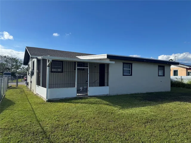 a view of an house with backyard space and balcony