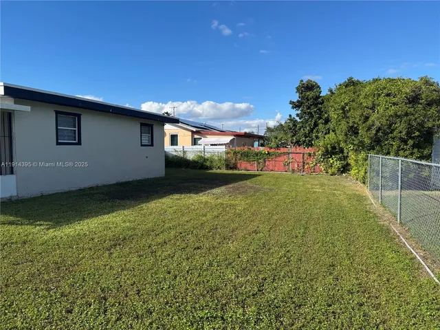 a view of a backyard of the house