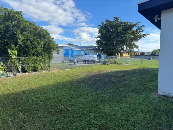a kitchen with stainless steel appliances kitchen island granite countertop a refrigerator and a stove top oven