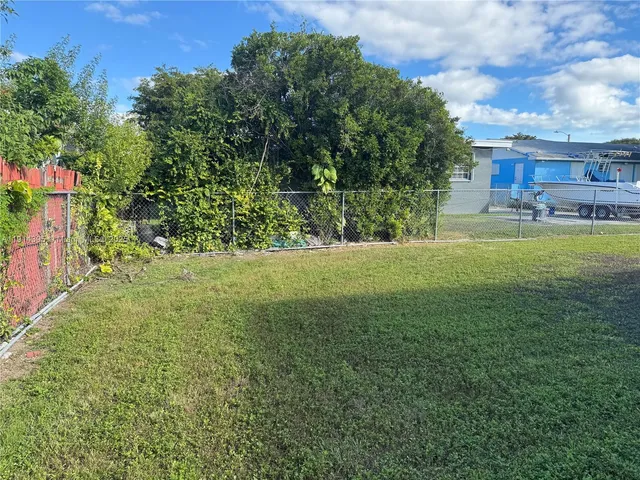 a kitchen with stainless steel appliances kitchen island granite countertop a refrigerator and a stove top oven