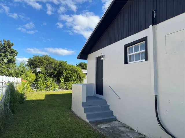 a bedroom with a bed and a ceiling fan