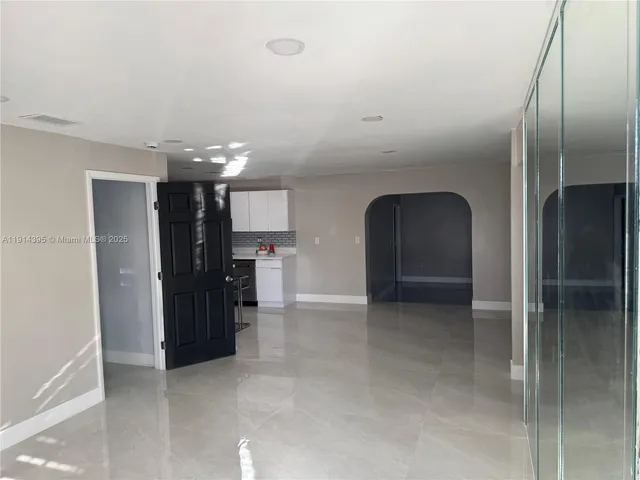 a kitchen with a sink and steel appliances