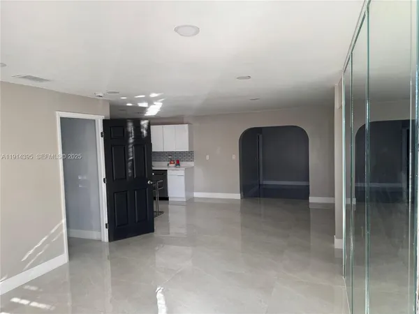 a kitchen with a sink and steel appliances