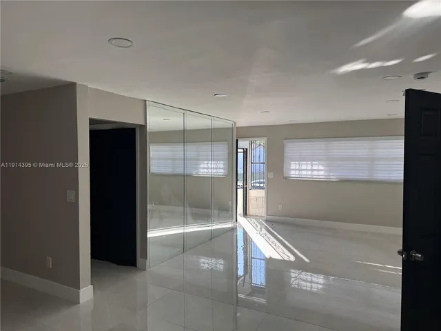 a kitchen with metallic refrigerator freezer and a sink