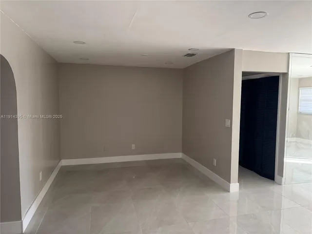 a kitchen with refrigerator and window