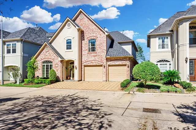 a view of white house with a yard and potted plants