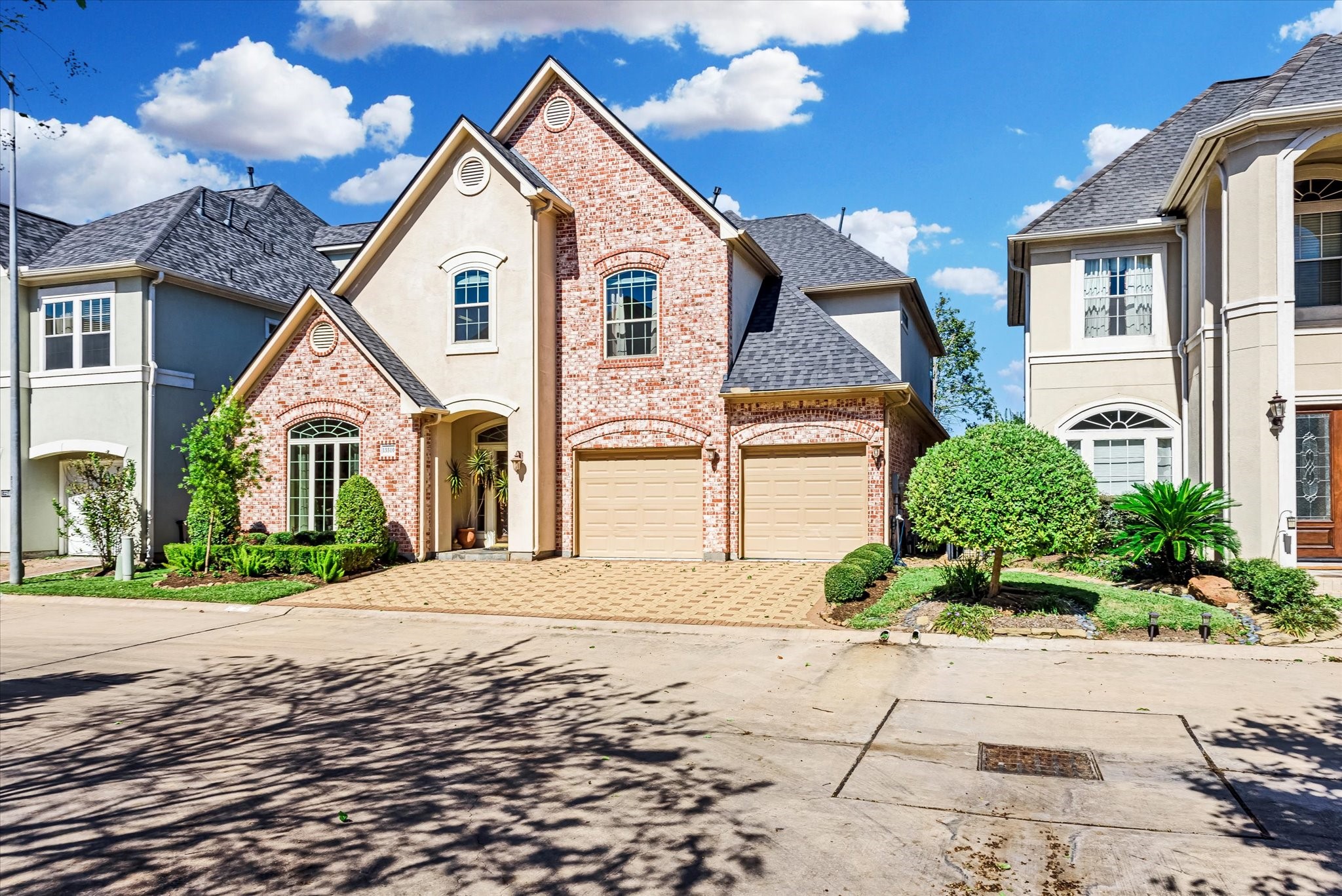 a view of white house with a yard and potted plants
