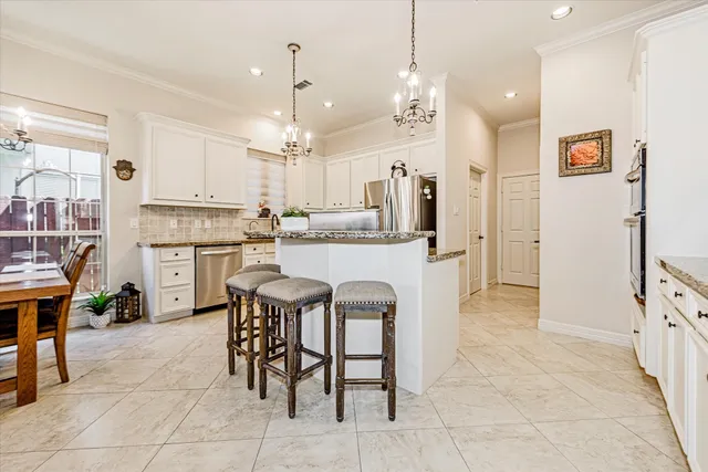 a kitchen with a stove a refrigerator and a dining table with wooden floor