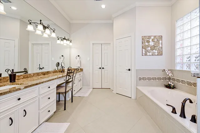 a spacious bathroom with a granite countertop sink a mirror and a shower
