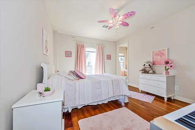 a spacious bedroom with a bed and a chandelier