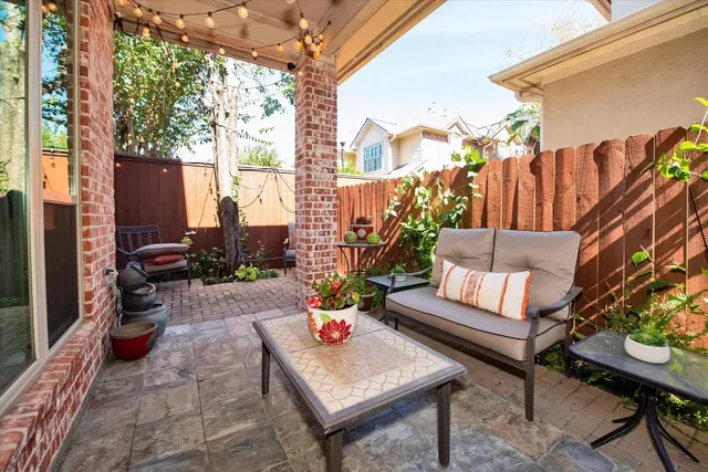 a backyard of a house with outdoor seating