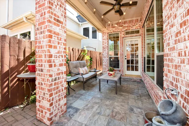 a backyard of a house with table and chairs