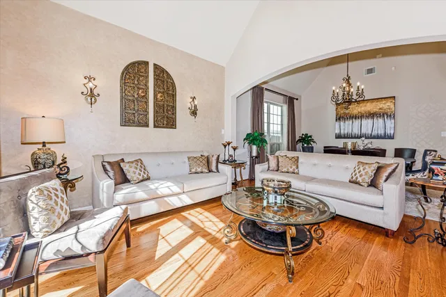 a view of a dining room with furniture and a chandelier